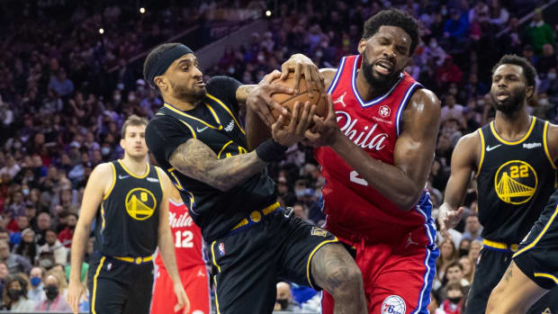Dec 11, 2021; Philadelphia, Pennsylvania, USA; Philadelphia 76ers center Joel Embiid (21) and Golden State Warriors guard Gary Payton II (0) battle for ball control at Wells Fargo Center. Mandatory Credit: Bill Streicher-USA TODAY Sports